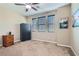 This carpeted bedroom includes three windows with blinds, a wardrobe, and tasteful artwork at 262 Inflection St, Henderson, NV 89011