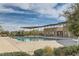 Community pool with shaded picnic tables, restrooms, and lush landscaping at 262 Inflection St, Henderson, NV 89011