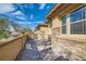 Property exterior view with a brick-paved entryway and decorative stone wall under bright skies at 262 Inflection St, Henderson, NV 89011