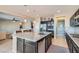 Open-concept kitchen with a granite island, stainless steel appliances, and seamless flow to the living area at 262 Inflection St, Henderson, NV 89011