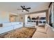 Spacious living room featuring two large couches, modern ceiling fan, and an open floor plan leading to the kitchen at 262 Inflection St, Henderson, NV 89011