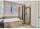 The spacious main bathroom offers a soaking tub with tiled surround and a separate shower with glass enclosure at 262 Inflection St, Henderson, NV 89011