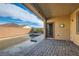 Covered patio with brick flooring, leading to a private backyard pool and block wall at 262 Inflection St, Henderson, NV 89011