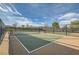 Community pickleball court with green surface, black fencing and shade structure, on a sunny day at 262 Inflection St, Henderson, NV 89011