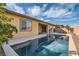 Inviting backyard pool with clear water, and a stucco home exterior with a covered patio area at 262 Inflection St, Henderson, NV 89011
