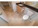 Bathroom with granite countertop vanity, toilet, and neutral tile flooring at 270 E Flamingo Rd # 136, Las Vegas, NV 89169