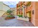 The Meridian courtyard with lush landscaping features mature trees and walkway to units at 270 E Flamingo Rd # 136, Las Vegas, NV 89169