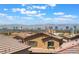 Expansive city view featuring a sprawling community of homes with the Las Vegas skyline and mountains in the background at 2767 Lindsey Springs St, Las Vegas, NV 89142