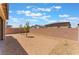 Open backyard featuring low maintenance rock landscaping, trees and a brick wall at 2767 Lindsey Springs St, Las Vegas, NV 89142
