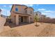 Spacious backyard with rock landscaping, a covered patio, and partial brick wall at 2767 Lindsey Springs St, Las Vegas, NV 89142