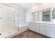 Modern bathroom with a glass shower, soaking tub, and dual sink vanity at 2767 Lindsey Springs St, Las Vegas, NV 89142