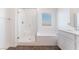 Well-lit bathroom with shower and soaking tub combination, and modern single vanity and fixtures at 2767 Lindsey Springs St, Las Vegas, NV 89142