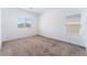 Bright bedroom with plush carpet, two windows, and neutral walls at 2767 Lindsey Springs St, Las Vegas, NV 89142