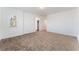 A bright bedroom with neutral walls and carpet has a view from the window and two access doors at 2767 Lindsey Springs St, Las Vegas, NV 89142