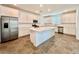 Spacious kitchen features white cabinets, stainless appliances, large island and tile floors at 2767 Lindsey Springs St, Las Vegas, NV 89142