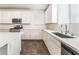 Kitchen view featuring stainless appliances, white cabinets, quartz counters, tile flooring and natural light at 2767 Lindsey Springs St, Las Vegas, NV 89142