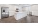 Spacious kitchen with stainless steel appliances, white cabinets, quartz countertops, and a large island at 2767 Lindsey Springs St, Las Vegas, NV 89142