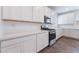 Bright kitchen offering white cabinets and quartz counters, along with stainless steel appliances at 2767 Lindsey Springs St, Las Vegas, NV 89142