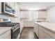 Bright kitchen featuring white cabinets, stainless steel appliances, and ample counter space for cooking at 2767 Lindsey Springs St, Las Vegas, NV 89142