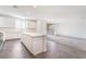 Open-concept kitchen with a large island, white cabinets, stainless appliances, and access to the living area at 2767 Lindsey Springs St, Las Vegas, NV 89142