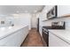 Kitchen boasts white cabinets, stainless appliances, gas range, and center island at 2767 Lindsey Springs St, Las Vegas, NV 89142