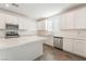 A modern kitchen featuring an island with stainless steel appliances, white cabinets and quartz countertops at 2767 Lindsey Springs St, Las Vegas, NV 89142
