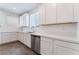 Kitchen featuring stainless steel dishwasher and sink plus white cabinets and quartz countertops at 2767 Lindsey Springs St, Las Vegas, NV 89142