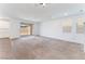 Bright living area with neutral carpeting, smooth transitions to the kitchen and sliding glass doors at 2767 Lindsey Springs St, Las Vegas, NV 89142