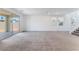 Spacious open-concept living area featuring neutral carpet and sliding glass doors at 2767 Lindsey Springs St, Las Vegas, NV 89142