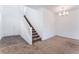 Cozy living area with a staircase and ample natural light, perfect for relaxation and comfort at 2767 Lindsey Springs St, Las Vegas, NV 89142