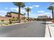 Gated community street view with palm trees, and lush landscaping creating curb appeal in a desert landscape at 2767 Lindsey Springs St, Las Vegas, NV 89142