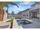 A tranquil backyard featuring a private pool, spa, lush landscaping and an outdoor living space at 2826 Barrow Downs St, Las Vegas, NV 89135