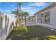 Landscaped backyard featuring artificial grass, palm trees, and a modern patio with a fire pit at 2826 Barrow Downs St, Las Vegas, NV 89135