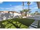 Spacious backyard features a lush lawn, modern patio, and a privacy wall with mature landscaping at 2826 Barrow Downs St, Las Vegas, NV 89135