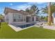Backyard with modern pool, turf, patio, and desert landscaping at 2826 Barrow Downs St, Las Vegas, NV 89135