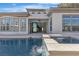 A tranquil backyard featuring a private pool, spa, lush landscaping and an outdoor living space at 2826 Barrow Downs St, Las Vegas, NV 89135