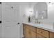 Bathroom vanity with white countertop, light wood cabinets, and gold hardware at 2826 Barrow Downs St, Las Vegas, NV 89135
