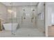 The bathroom showcases a glass shower, free standing tub, gold hardware and chandelier at 2826 Barrow Downs St, Las Vegas, NV 89135