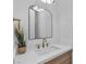 Stylish bathroom with modern fixtures, a white quartz countertop, and a decorative mirror at 2826 Barrow Downs St, Las Vegas, NV 89135