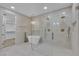 Spa-like bathroom showcasing a freestanding tub, glass shower, modern fixtures, and elegant tile at 2826 Barrow Downs St, Las Vegas, NV 89135