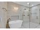This bathroom showcases a modern freestanding tub under a glass chandelier and glass shower at 2826 Barrow Downs St, Las Vegas, NV 89135