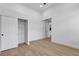 Well-lit bedroom featuring neutral walls, wood-look floors, and a closet with sliding doors at 2826 Barrow Downs St, Las Vegas, NV 89135