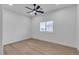 Bright bedroom with wood-look floors, a modern ceiling fan, and plantation shutters at 2826 Barrow Downs St, Las Vegas, NV 89135