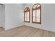 Comfortable bedroom with wood-look flooring and arched windows with plantation shutters at 2826 Barrow Downs St, Las Vegas, NV 89135