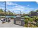 Community amenities featuring outdoor grill, seating area and tennis courts at 2826 Barrow Downs St, Las Vegas, NV 89135