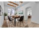 Bright dining room with wood beam ceiling, stylish chandelier, and modern furnishings at 2826 Barrow Downs St, Las Vegas, NV 89135