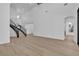 Grand foyer featuring staircase with decorative iron railing and light wood floors at 2826 Barrow Downs St, Las Vegas, NV 89135