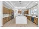 Bright kitchen with white quartz island, stainless steel appliances, and light wood cabinets at 2826 Barrow Downs St, Las Vegas, NV 89135