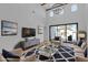 Bright, high-ceilinged living room with modern decor, stylish rug and a glass topped coffee table at 2826 Barrow Downs St, Las Vegas, NV 89135