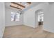 Spacious living room with wood-look flooring, beamed ceiling, and large windows for plenty of light at 2826 Barrow Downs St, Las Vegas, NV 89135